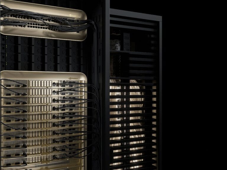 close up of two racks of gold and black computers racks with black and gold wiring connecting the computers